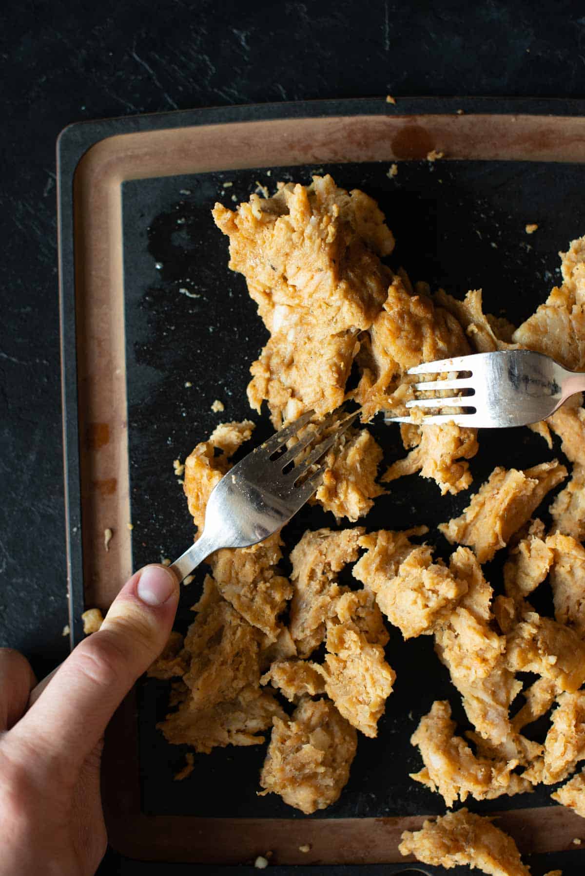 picture showing two forks shredding the vegan shredded chicken