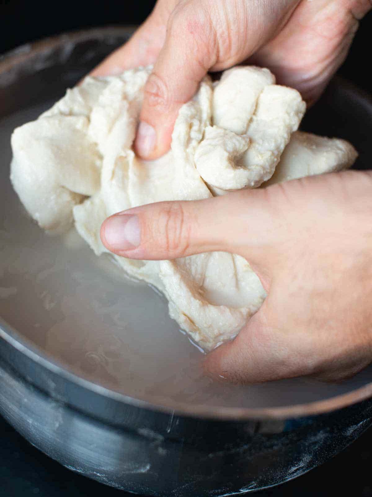 This image shows how to knead and squeeze the dough in the water.