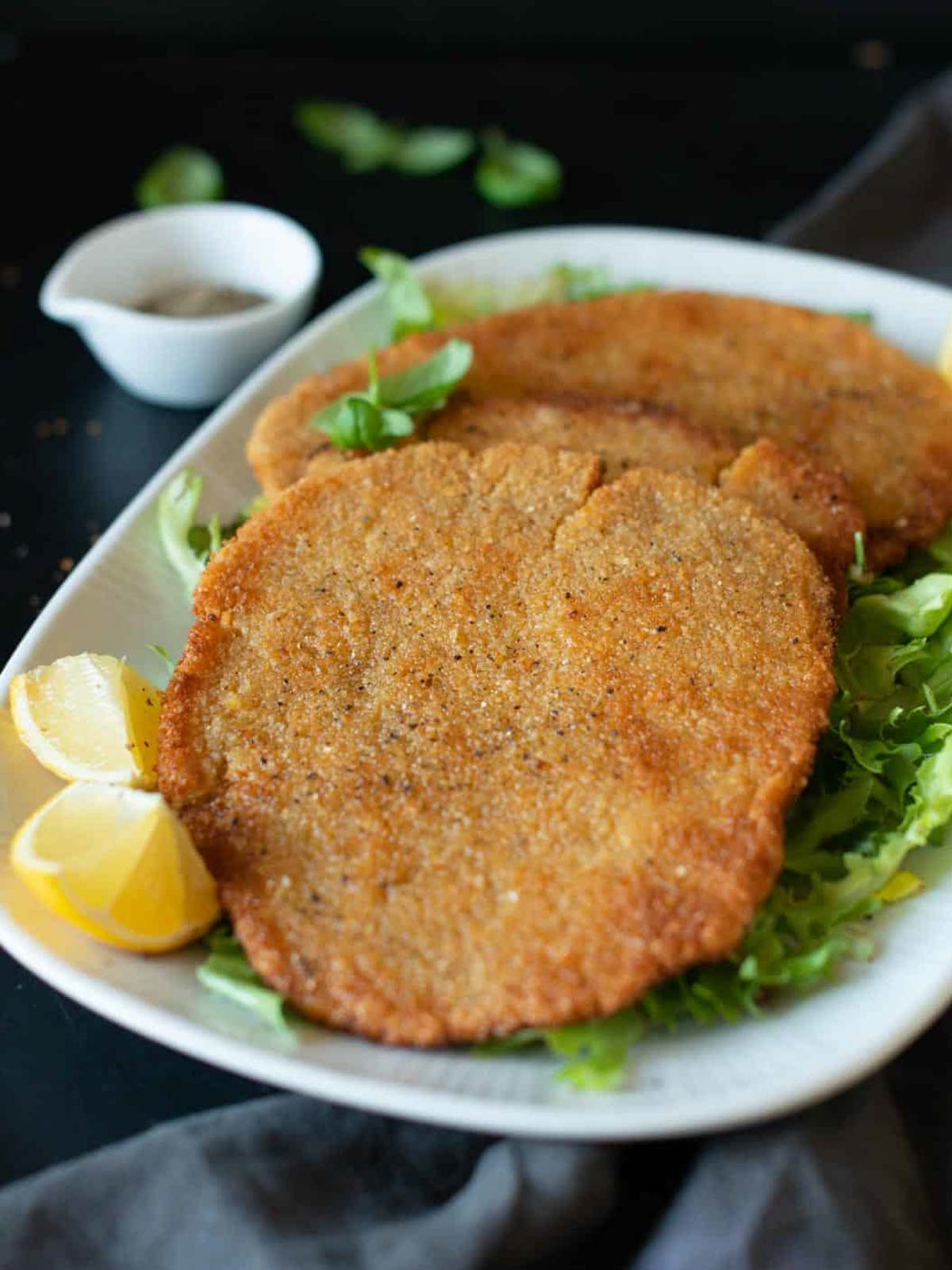 vegan chickpea cutlets served on a serving dish with lemon slices
