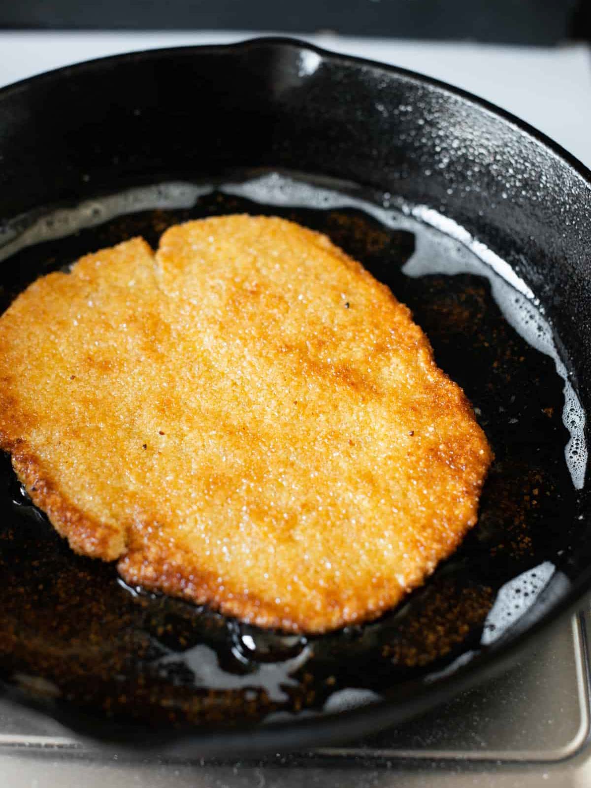 image showing a chickpea cutlet getting fried.