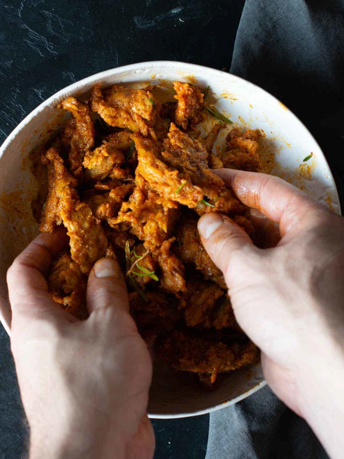 this image shows he seitan chunks getting mixed and coated with marinade