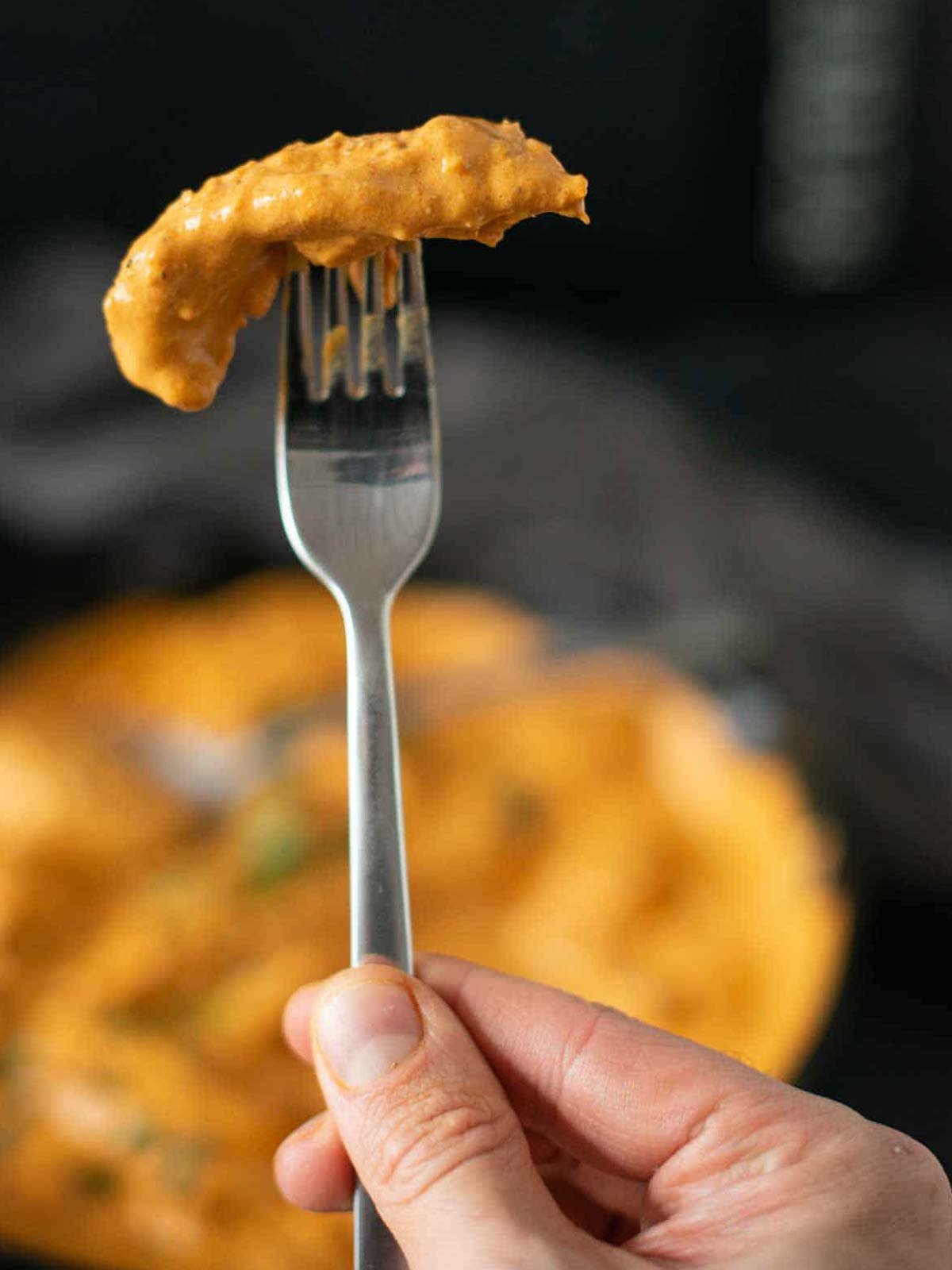 the image shows a fork with a piece of vegan butter chicken on it.