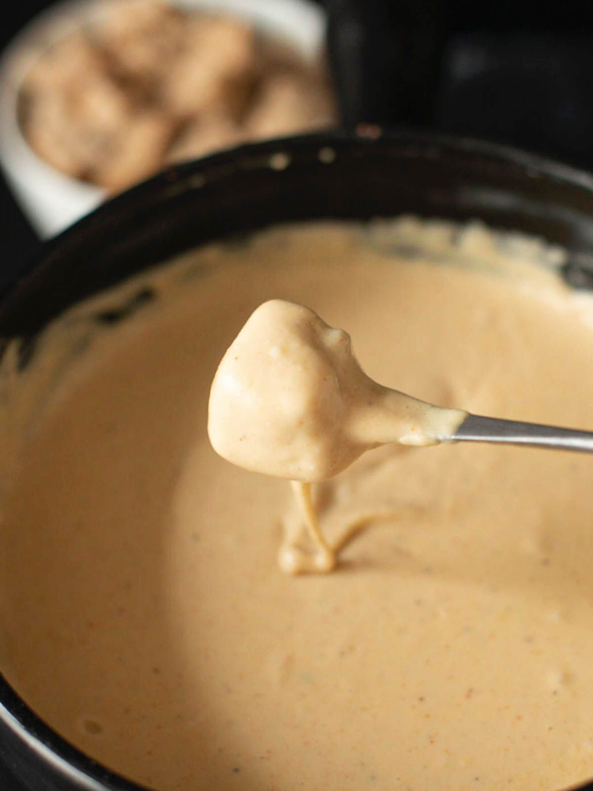 image of bread covered with vegan fondue