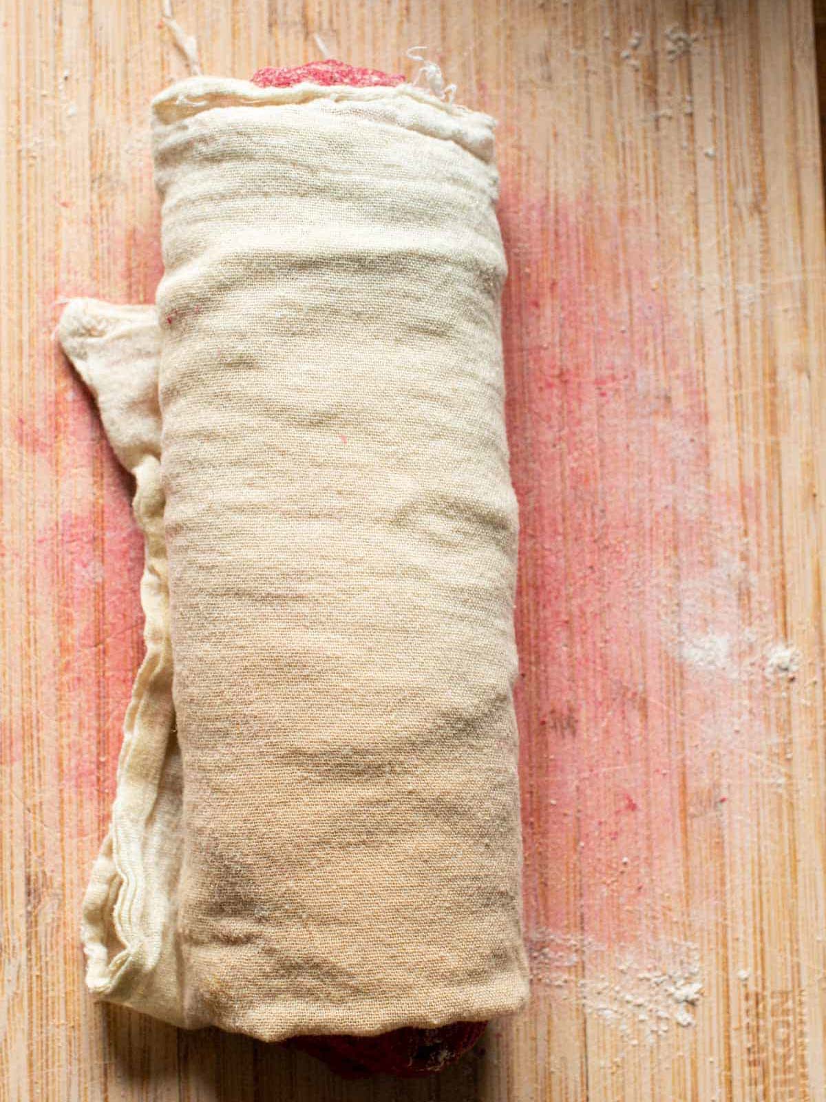 this image shows the vegan seitan fillet wrapped in cheese cloth.