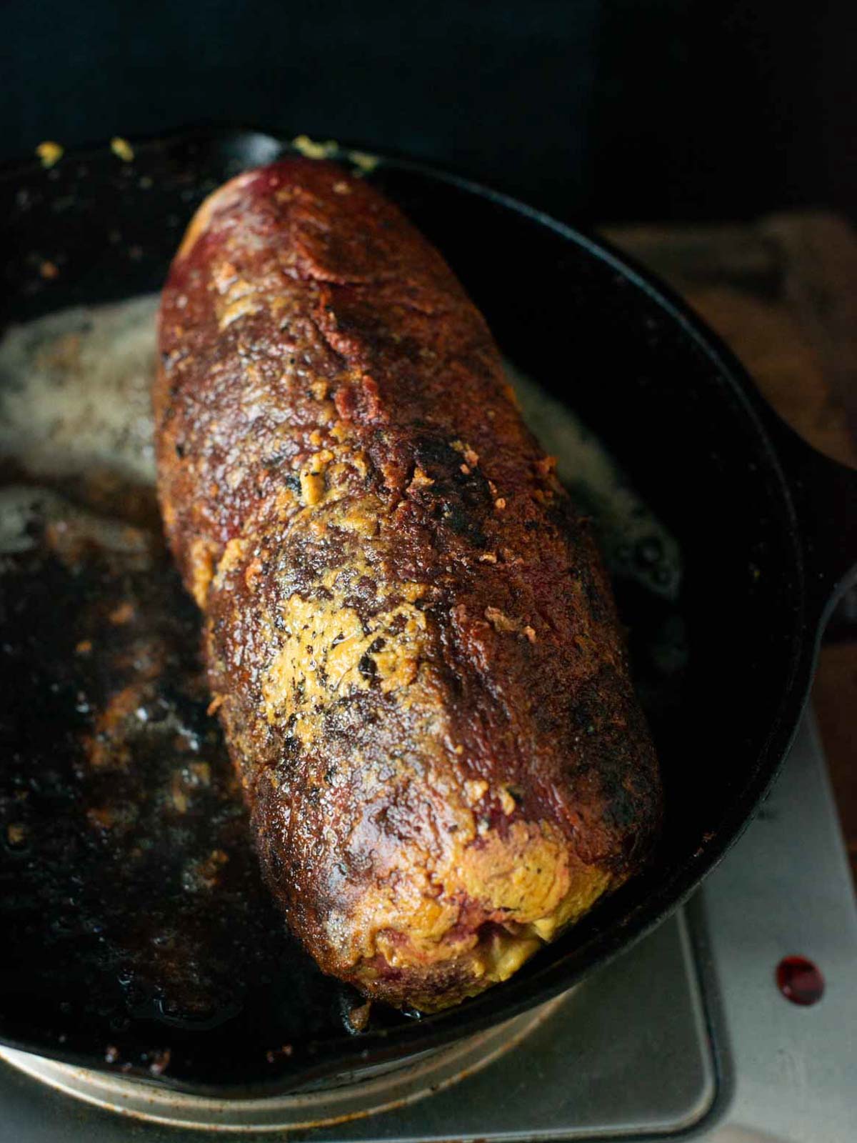 this image shows the vegan seitan fillet getting seared in a pan.