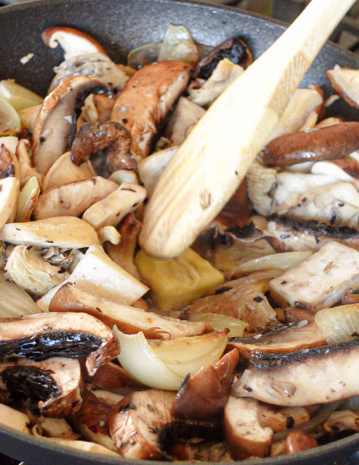 image: mushrooms cooking in a pan