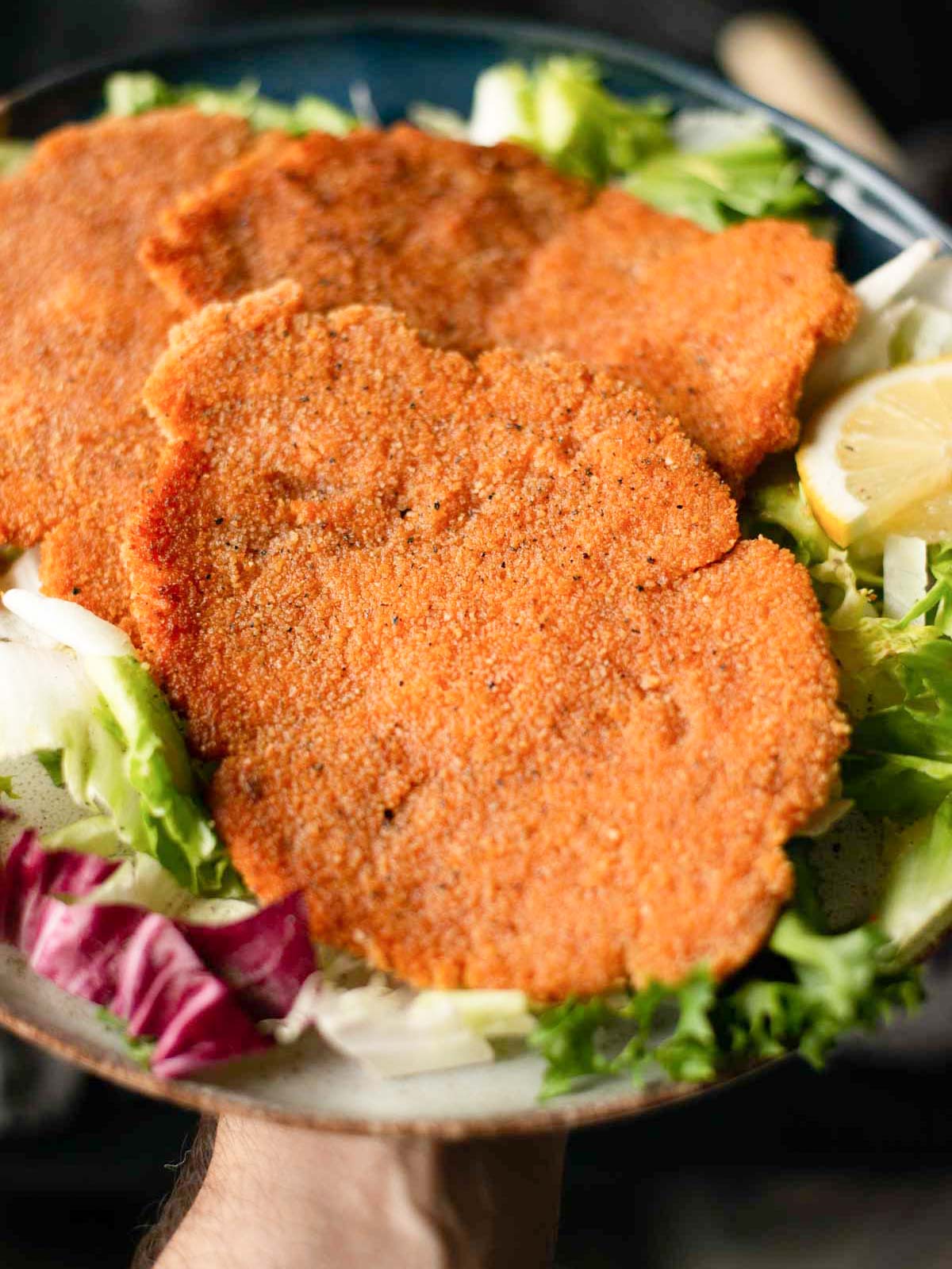 the image shows vegan wiener schnitzels ready to be served.